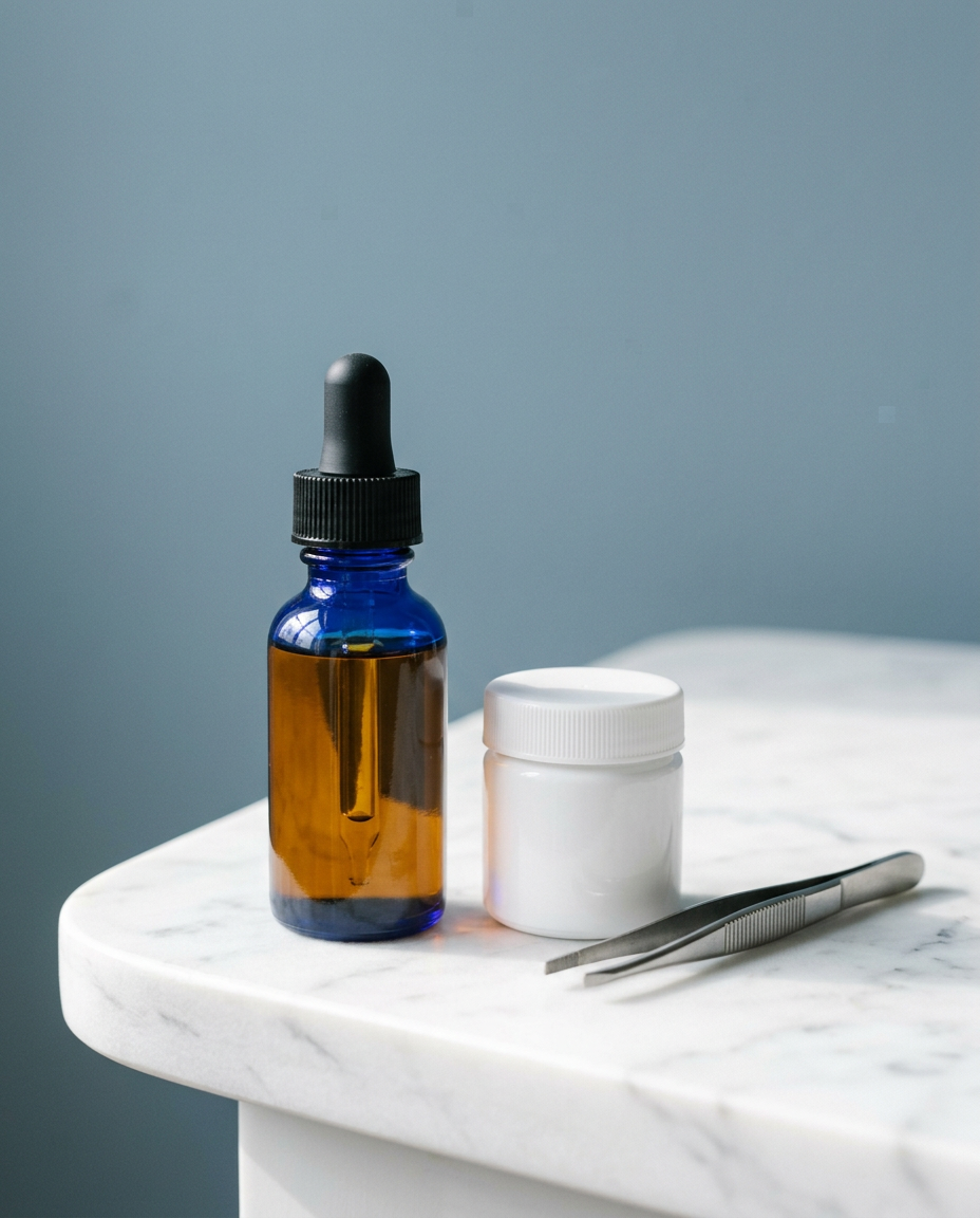 An amber dropper bottle and a sealed white pharmaceutical jar